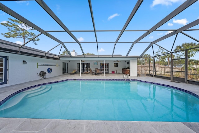 outdoor pool featuring ceiling fan, a patio, and a lanai