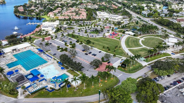 drone / aerial view of a large body of water and a pool