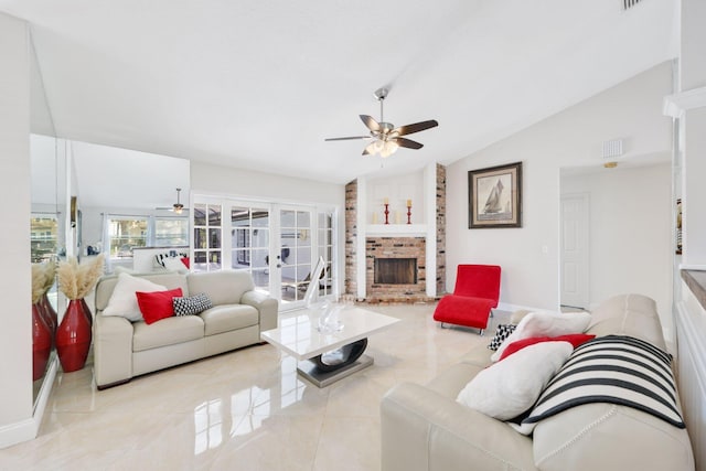 living room with a ceiling fan, vaulted ceiling, a brick fireplace, and baseboards