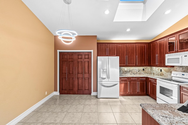 6346 San Michel Way, Delray Beach, FL 33484 - kitchen with backsplash, light stone counters, dark brown cabinets, and white appliances
