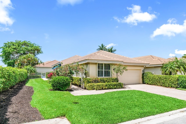 6346 San Michel Way, Delray Beach, FL 33484 - ranch-style home featuring concrete driveway, a front lawn, a tiled roof, an attached garage, and stucco siding