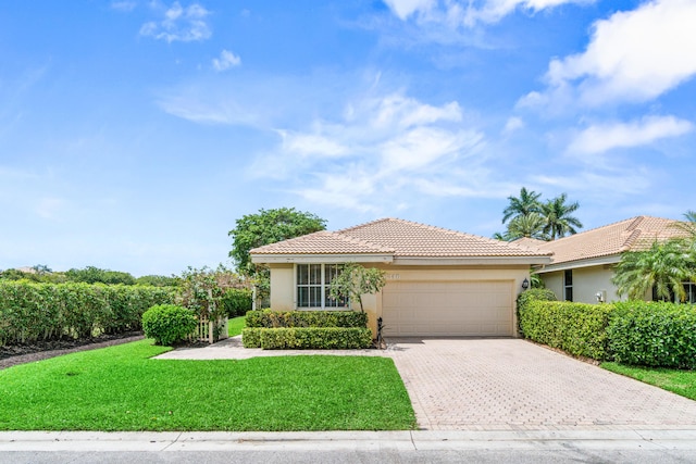 6346 San Michel Way, Delray Beach, FL 33484 - view of front of property with a tile roof, a front lawn, driveway, a garage, and stucco siding