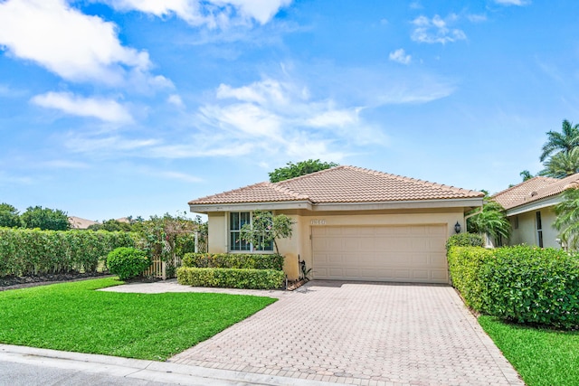 6346 San Michel Way, Delray Beach, FL 33484 - view of front of home with stucco siding, a tile roof, decorative driveway, and a garage