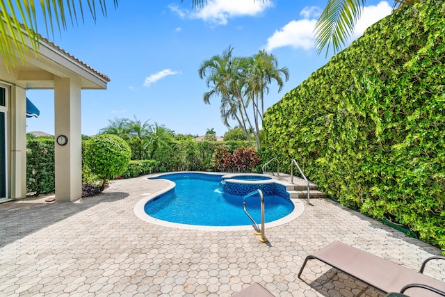 6346 San Michel Way, Delray Beach, FL 33484 - view of swimming pool with a pool with connected hot tub and a patio