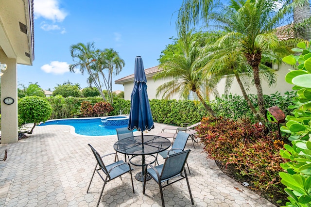6346 San Michel Way, Delray Beach, FL 33484 - view of pool featuring a patio area, a fenced backyard, a pool with connected hot tub, and outdoor dining space