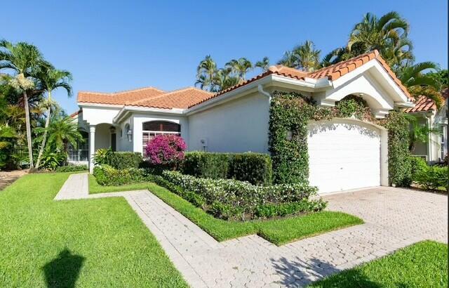 12624 Mallet Cir, Wellington, FL 33414 - mediterranean / spanish house with decorative driveway, a tile roof, stucco siding, and a garage