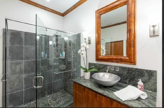 12624 Mallet Cir, Wellington, FL 33414 - bathroom featuring ornamental molding, vanity, a stall shower, and tasteful backsplash