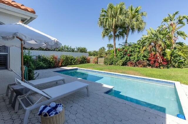 12624 Mallet Cir, Wellington, FL 33414 - view of swimming pool with a fenced in pool, a lawn, fence, and a patio area