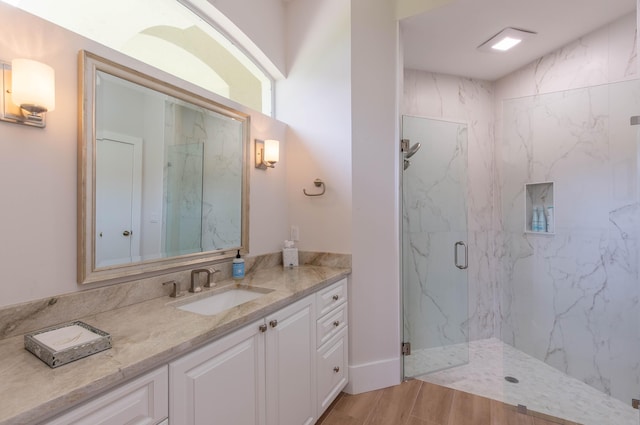 12624 Mallet Cir, Wellington, FL 33414 - bathroom with vanity, a marble finish shower, and wood finished floors