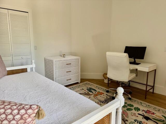 12624 Mallet Cir, Wellington, FL 33414 - bedroom featuring wood finished floors, baseboards, a closet, and a desk