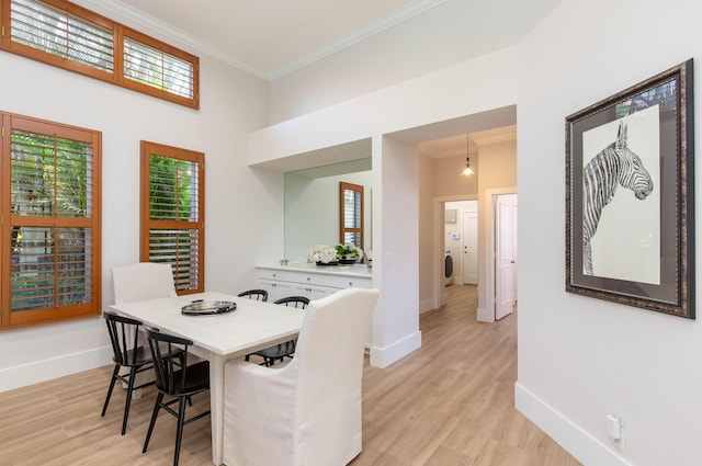 12624 Mallet Cir, Wellington, FL 33414 - dining area featuring crown molding, baseboards, and light wood-type flooring