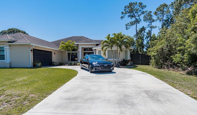 single story home with stucco siding, driveway, a garage, and a front lawn