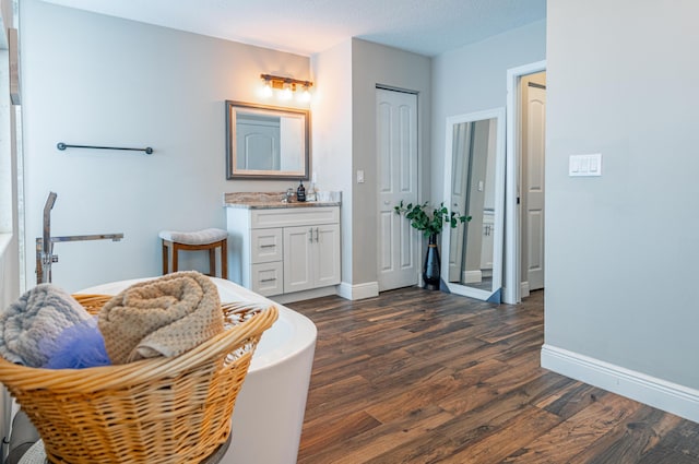 full bathroom with vanity, baseboards, and wood finished floors