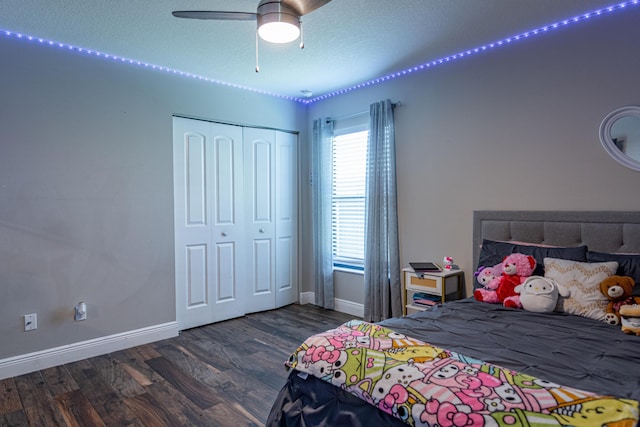 bedroom with a closet, baseboards, ceiling fan, and wood finished floors