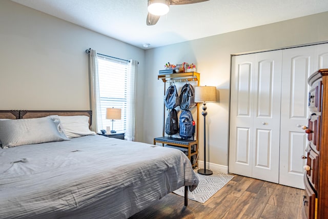 bedroom with ceiling fan, a closet, baseboards, and wood finished floors