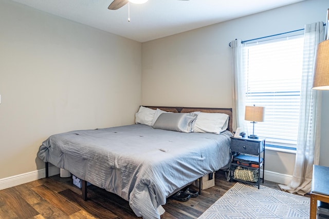 bedroom with baseboards, ceiling fan, and wood finished floors