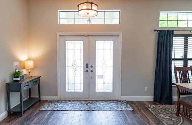 foyer entrance featuring french doors, baseboards, and dark wood-style floors