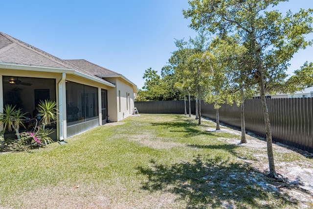 view of yard with a sunroom and a fenced backyard
