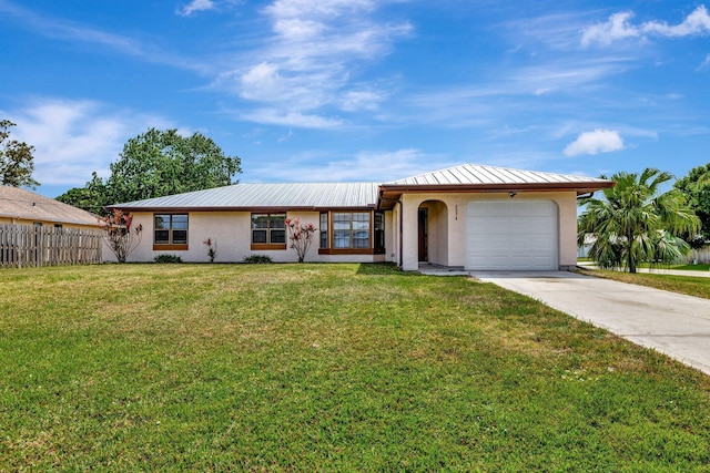 ranch-style house with a garage, concrete driveway, fence, a front yard, and stucco siding