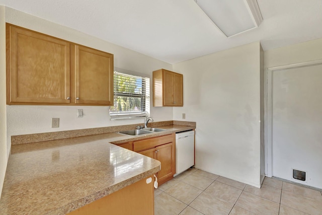 kitchen with white dishwasher, light countertops, light tile patterned floors, and a sink