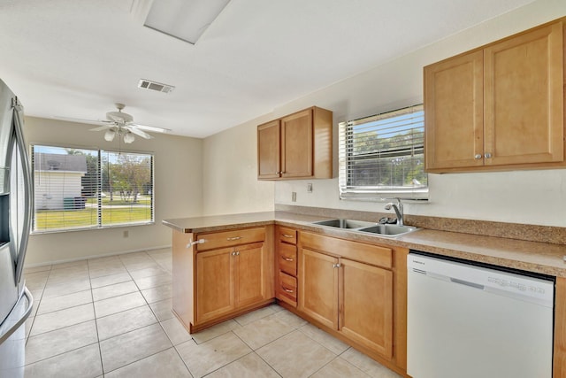 kitchen featuring dishwasher, visible vents, a healthy amount of sunlight, and a sink