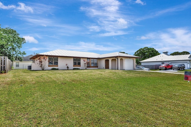 ranch-style home with concrete driveway, an attached garage, fence, and a front lawn