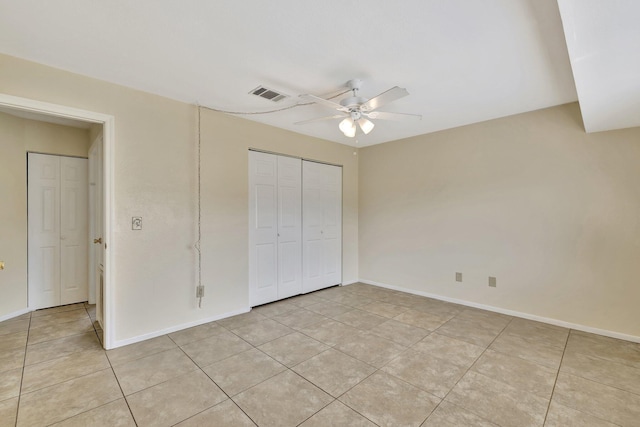 unfurnished bedroom featuring visible vents, a closet, and light tile patterned floors