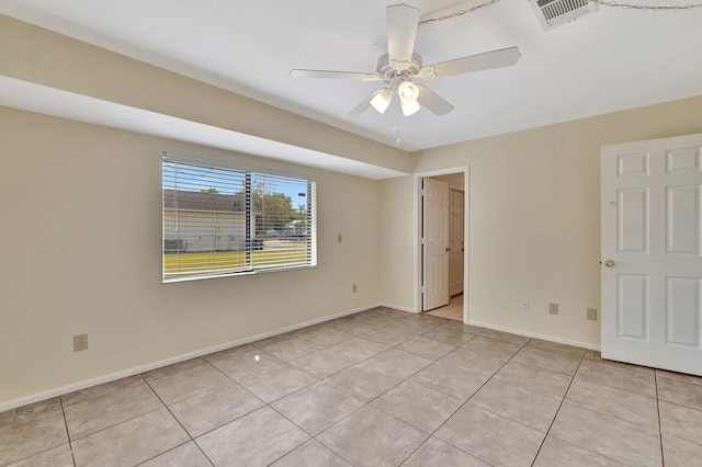 spare room featuring ceiling fan, baseboards, visible vents, and light tile patterned floors