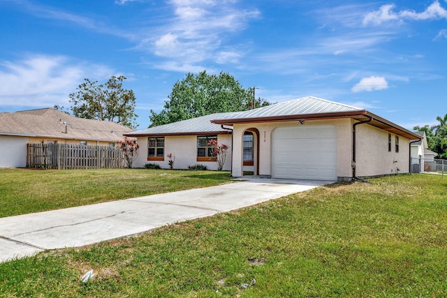 single story home with concrete driveway, an attached garage, fence, a front yard, and metal roof