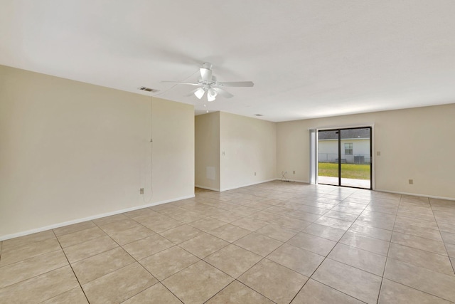 empty room with visible vents, baseboards, ceiling fan, and light tile patterned floors