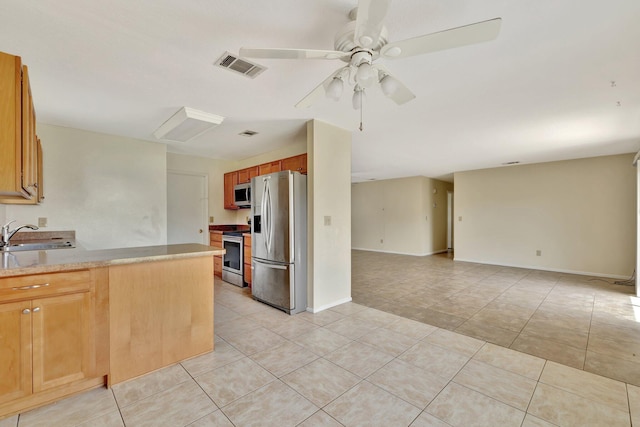 kitchen with stainless steel appliances, visible vents, a ceiling fan, light tile patterned floors, and a sink