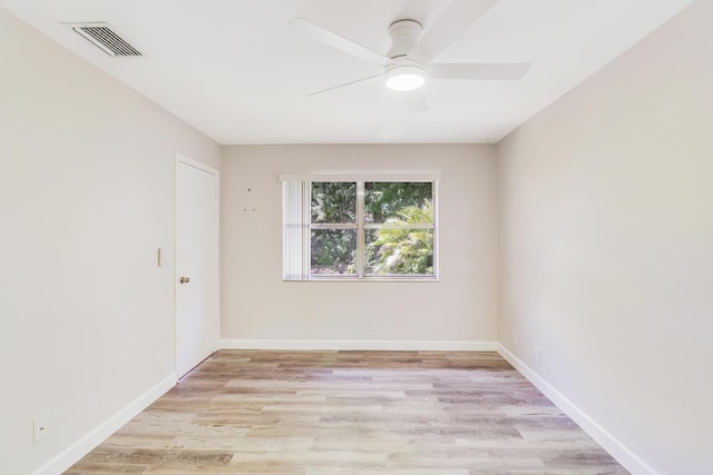 unfurnished room featuring a ceiling fan, baseboards, visible vents, and light wood finished floors