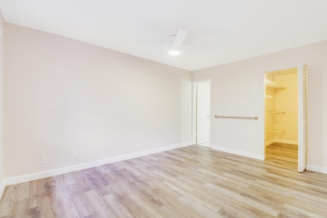 unfurnished room featuring baseboards and light wood-style floors