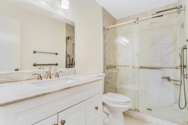 full bath with toilet, a marble finish shower, marble finish floor, and vanity