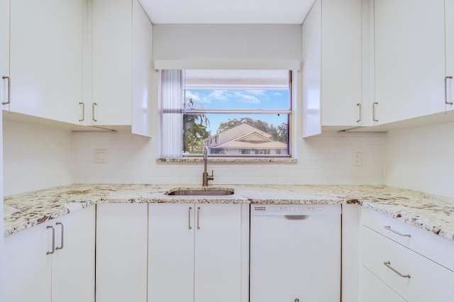 kitchen featuring a sink, backsplash, white cabinetry, and dishwasher