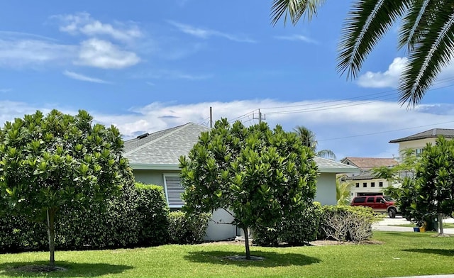6401 NE 7th Ave, Boca Raton, FL 33487 - view of side of property with stucco siding, a yard, and a shingled roof