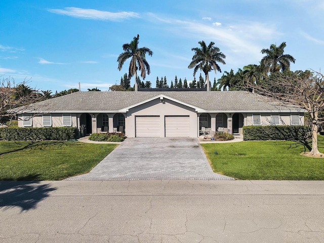6401 NE 7th Ave, Boca Raton, FL 33487 - ranch-style house featuring a garage, driveway, a front lawn, and stucco siding