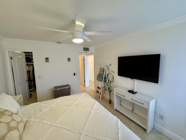 bedroom featuring a closet, a spacious closet, baseboards, visible vents, and ceiling fan