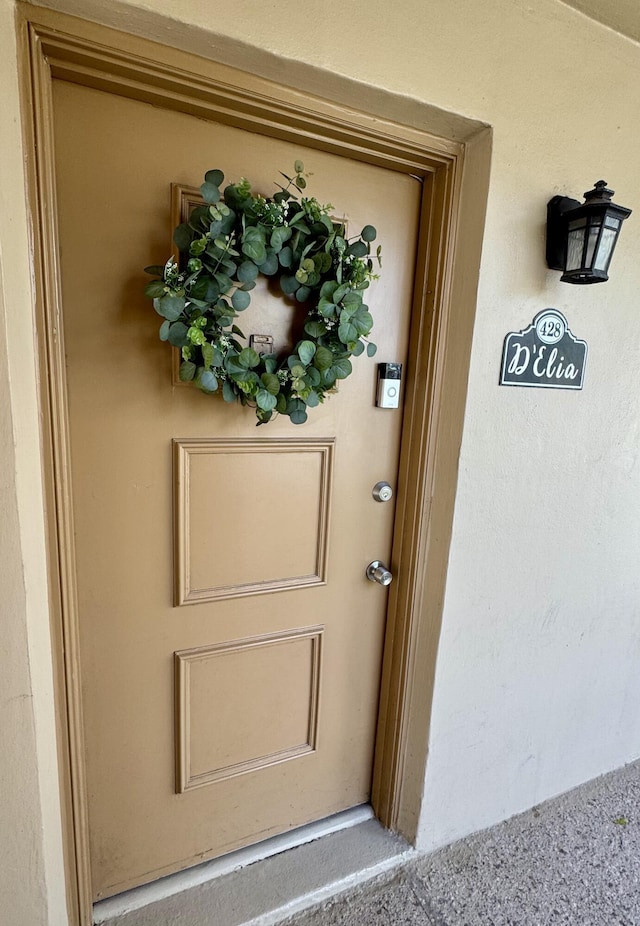 doorway to property featuring stucco siding