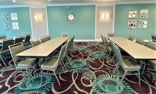 dining room featuring baseboards and ornamental molding