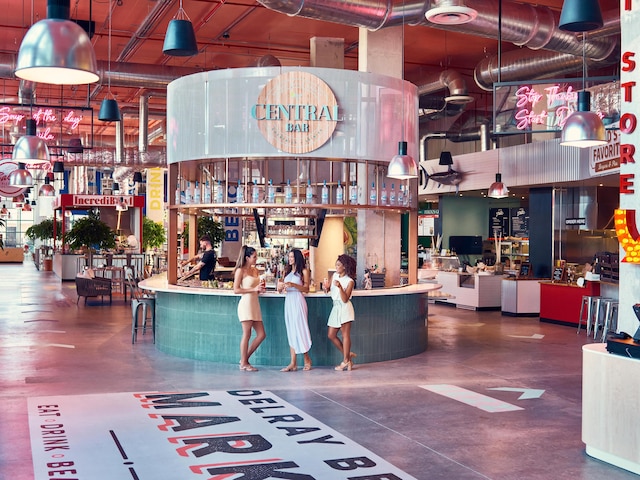 interior space with a towering ceiling, a community bar, and finished concrete floors