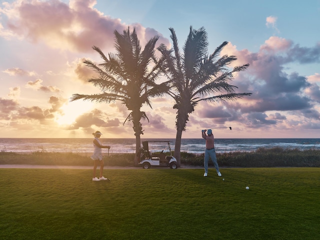 surrounding community with a lawn and a water view