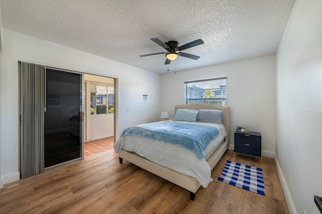 bedroom featuring a textured ceiling, a closet, light wood-style flooring, and visible vents