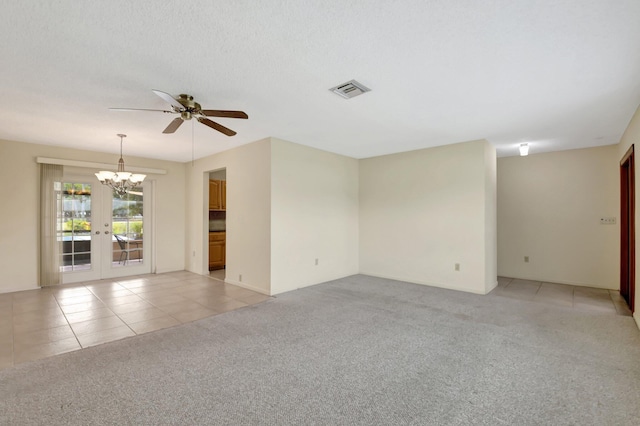 7140 Bobalink Ct, Lake Worth, FL 33467 - spare room featuring visible vents, light carpet, light tile patterned flooring, baseboards, and ceiling fan with notable chandelier