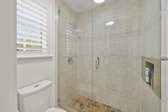 full bathroom with toilet and a stall shower