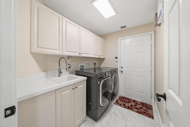 laundry room with a sink, marble finish floor, cabinet space, washing machine and dryer, and visible vents