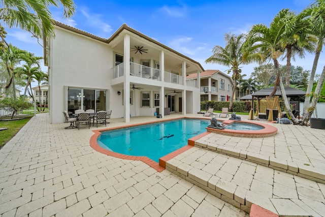 view of pool featuring a gazebo, a patio area, an in ground hot tub, and ceiling fan