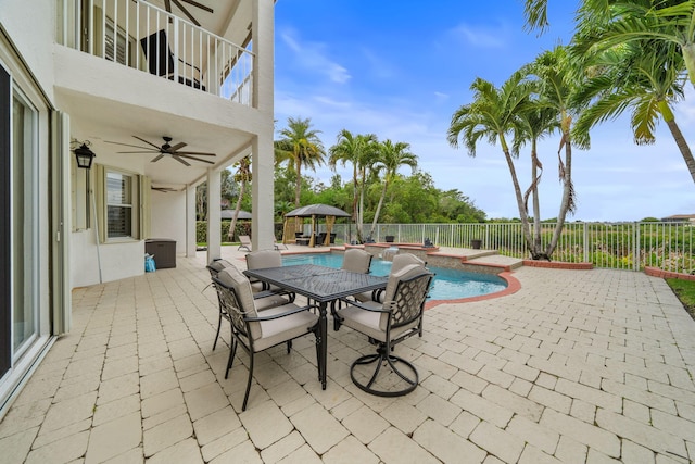 view of pool with a patio area, a ceiling fan, a fenced backyard, outdoor dining area, and a fenced in pool