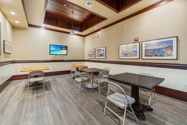 rec room featuring a tray ceiling, baseboards, visible vents, wood finished floors, and wooden ceiling