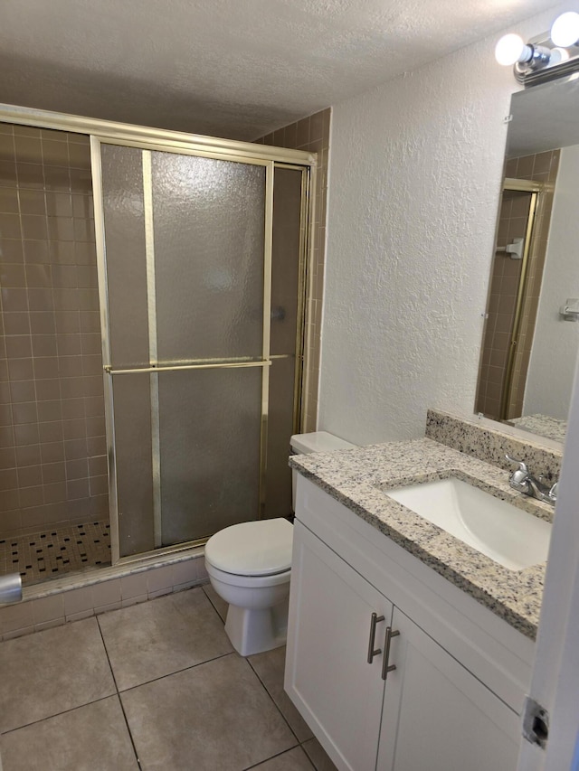 full bathroom with a textured ceiling, a textured wall, and a stall shower